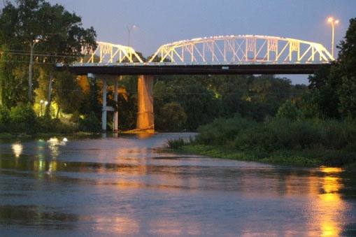 The Old Iron Bridge over the Colorado River in Bastrop, lit up at night